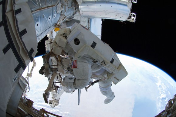 NASA astronaut Ron Garan (who was on Expedition 28 while Atlantis was docked to the International Space Station for STS-135) adjusts his tethers early in a spacewalk July 12, 2011. Credit: NASA