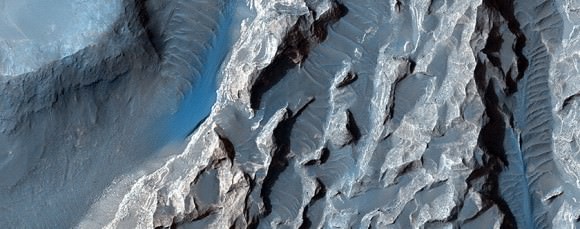 A close-up of "chaotic terrain" in Valles Marineris imaged by the Mars Reconnaissance Orbiter's HiRISE camera. Wind or fluid may have further shaped this region, which could be related to possible signs of an ancient lake found in other regions of Valles Marineris. Credit: NASA/JPL/University of Arizona 
