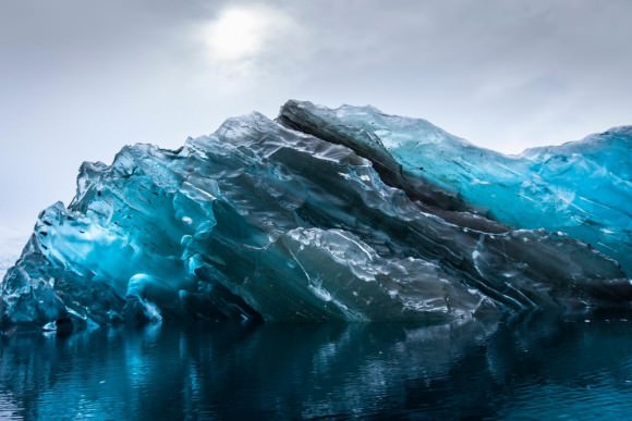 This stunning glacial portrait was photographed in Cierva Cove, Antarctica. An incredibly rare sight--this photo reveals the beautiful colors and pure surface of the underside of an iceberg. Credit and copyright: Alex Cornell. 