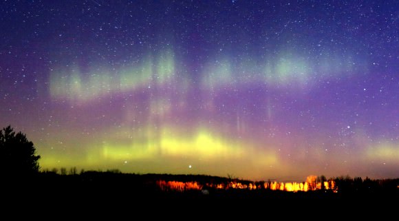 Curtains of aurora still pushed through the growing light of dawn. Credit: Bob King