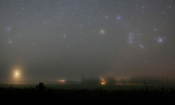 Color by fog. The colors of stars are accentuated when photographed through fog or light cloud. Orion at right with the crescent moon at lower left. Credit: Bob King