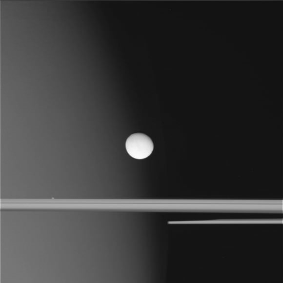 Enceladus hovers over Saturn's rings in this raw image from the Cassini spacecraft taken on October 14, 2015.  Credit: NASA/JPL-Caltech/Space Science Institute. 
