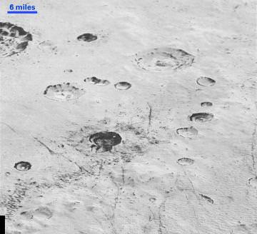 Layered Craters and Icy Plains: Pluto’s rugged, icy cratered plains include layering in the interior walls of many craters. Layers in geology usually mean an important change in composition or event, but at the moment New Horizons team members do not know if they are seeing local, regional or global layering. Credit: NASA/Johns Hopkins University Applied Physics Laboratory/Southwest Research Institute.