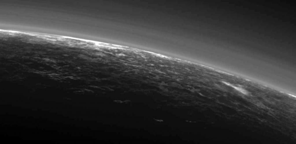 Recent images sent by NASA's New Horizons spacecraft show possible clouds floating over the frozen landscape including the streaky patch at right. Credit: NASA/JHUAPL/SwR