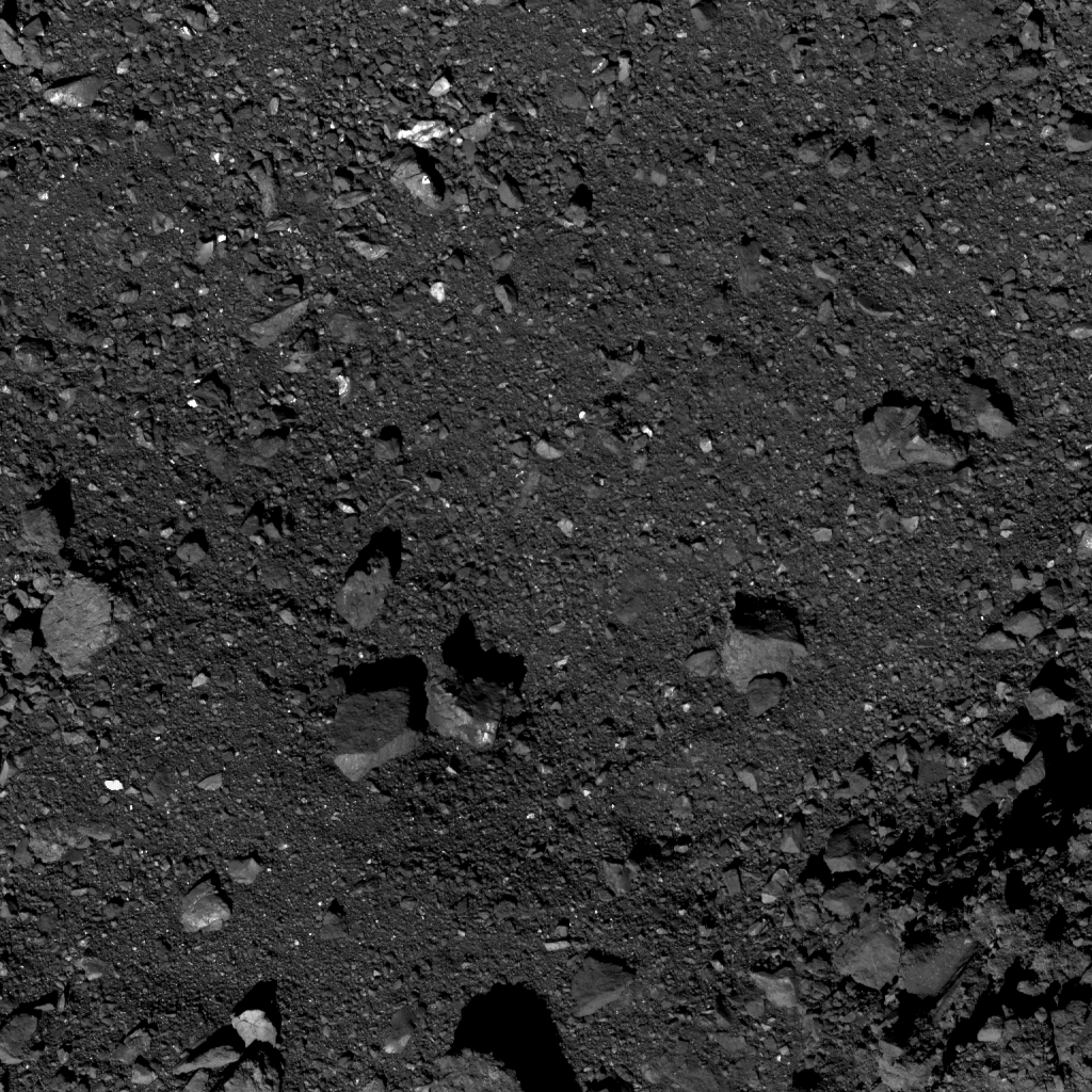  This is the highest-resolution image captured of candidate sample site Nightingale as of October 26. Site Nightingale is located near asteroid Bennu’s north pole. The crater’s center is visible in the top center of the image, which contains an accumulation of smaller rocks. The image was taken by the PolyCam camera on NASA’s OSIRIS-REx spacecraft on October 26, from a distance of 0.6 miles (1 km). The field of view is 47 ft (14.4 m). For reference, the light-colored boulder (far left center) is 5 ft (1.4 m) long, which is about the length of a bicycle.  Image Credit:  NASA/Goddard/University of Arizona  