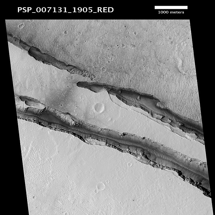 The HiRise instrument on the Mars Reconnaissance Orbiter captured this image of some faults in the Cerberus Fossae Region. The two strongest Marsquakes that InSight detected originated in the Cerberus Fossae Region. Image Credit: By Jim Secosky / WolfmanSF modified NASA / JPL / University of Arizona image - http://hirise.lpl.arizona.edu/PSP_007131_1905, Public Domain, https://commons.wikimedia.org/w/index.php?curid=6070792