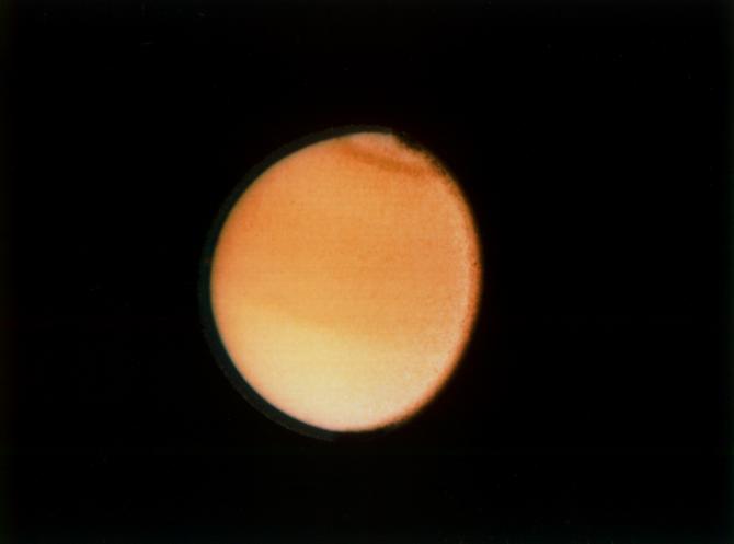 Voyager 2 captured this image of Titan in 1981 from a distance of 2.3 million km (1.4 million miles.) It shows some detail in the clouds, but not much. Image Credit: NASA/JPL