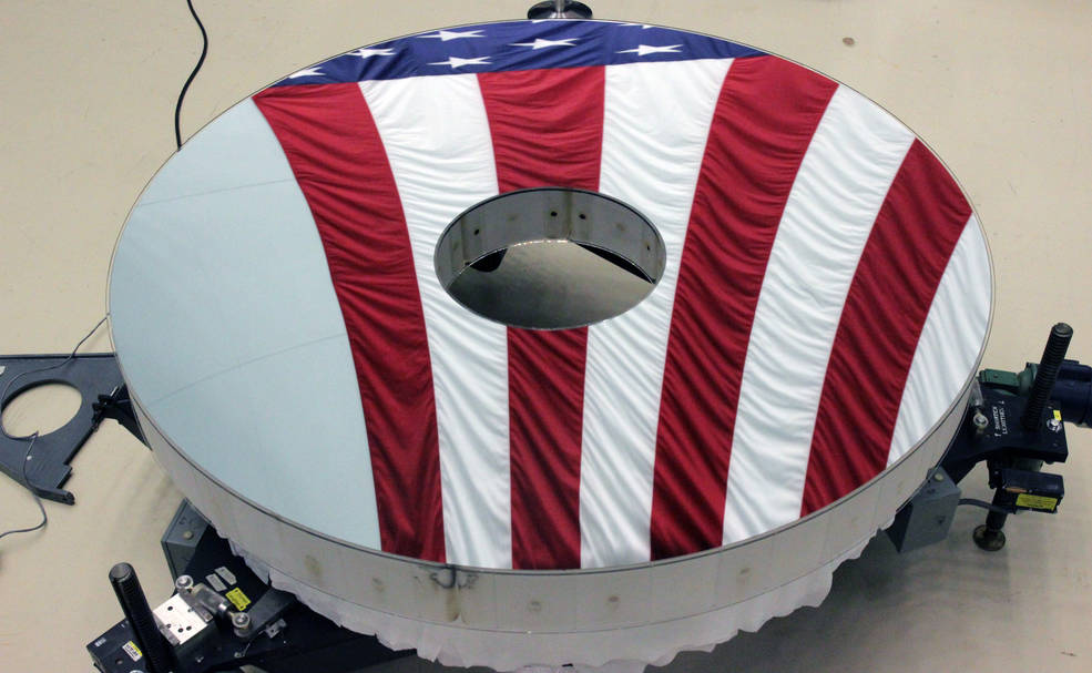 The Roman Space Telescope's primary mirror reflecting the American flag. Image Credit: L3Harris Technologies