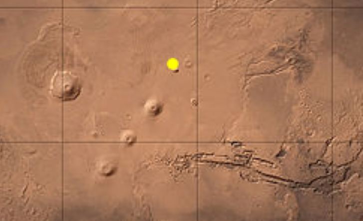 The study showed a strong connection between known volcanic areas and reflectivity. This image shows the Uranius Tholus shield volcano in yellow. The team found strong reflections to the east of the volcano. Image Credit: Wikimedia
