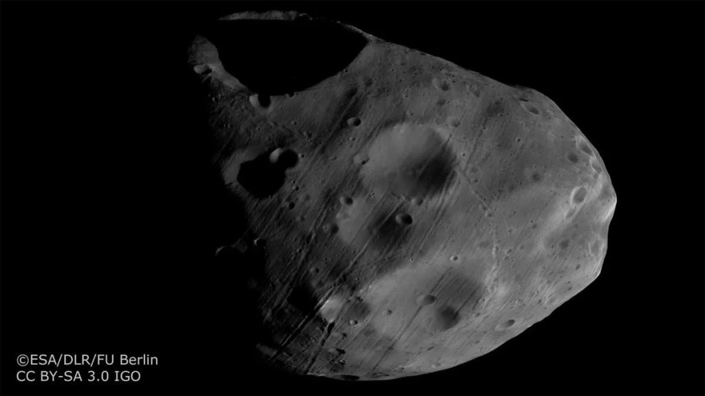 The HRSC captured this image of Phobos in 2017. It shows the Stickney Crater, Phobos' largest impact crater, and the unusual grooves on the moon's surface. Mars Express images helped scientists conclude that the grooves are likely from impact ejecta. Image Credit: ESA/DLR/FU Berlin. CC BY-SA 3.0 IGO