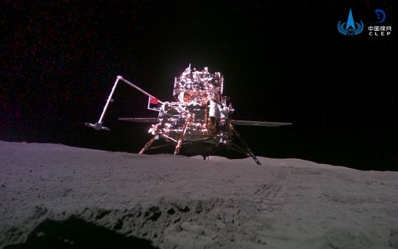 Chang'e-6 lander on the lunar surface, as seen by a mini-rover nearby. 