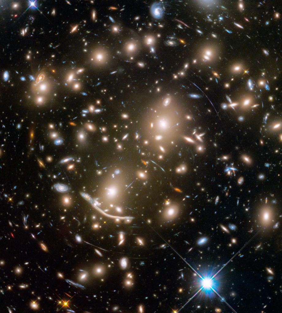 This Hubble Space Telescope mosaic shows a portion of the immense Coma galaxy cluster that contains more than 1,000 galaxies and is located 300 million light-years away. The rapid motion of its galaxies was the first clue that dark matter existed. Image Credit: NASA, ESA, J. Mack (STScI) and J. Madrid (Australian Telescope National Facility