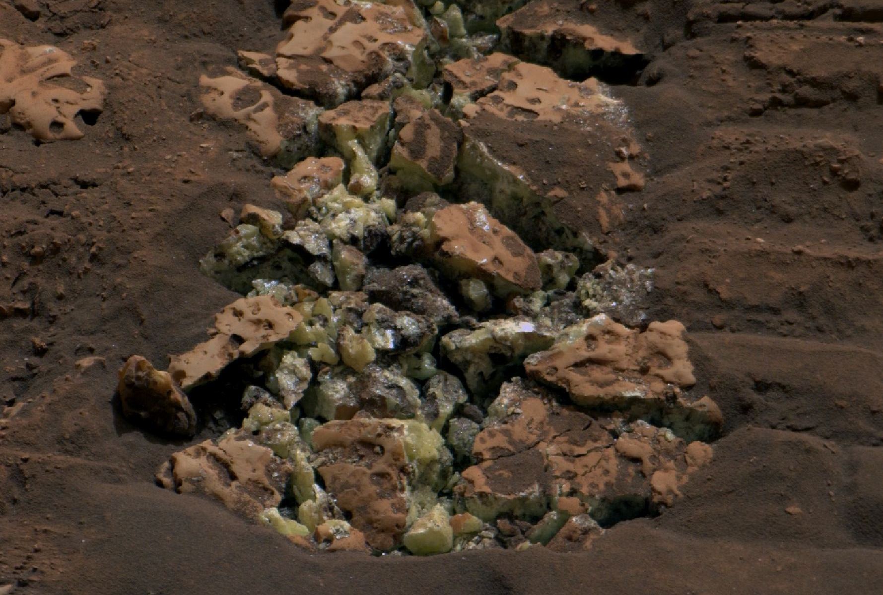 The Mars Curiosity rover rolled over this rock containing pure sulfur crystals in May. Planetary scientists are still trying to figure out how the sulfur got there. NASA/JPL-Caltech/MSSS