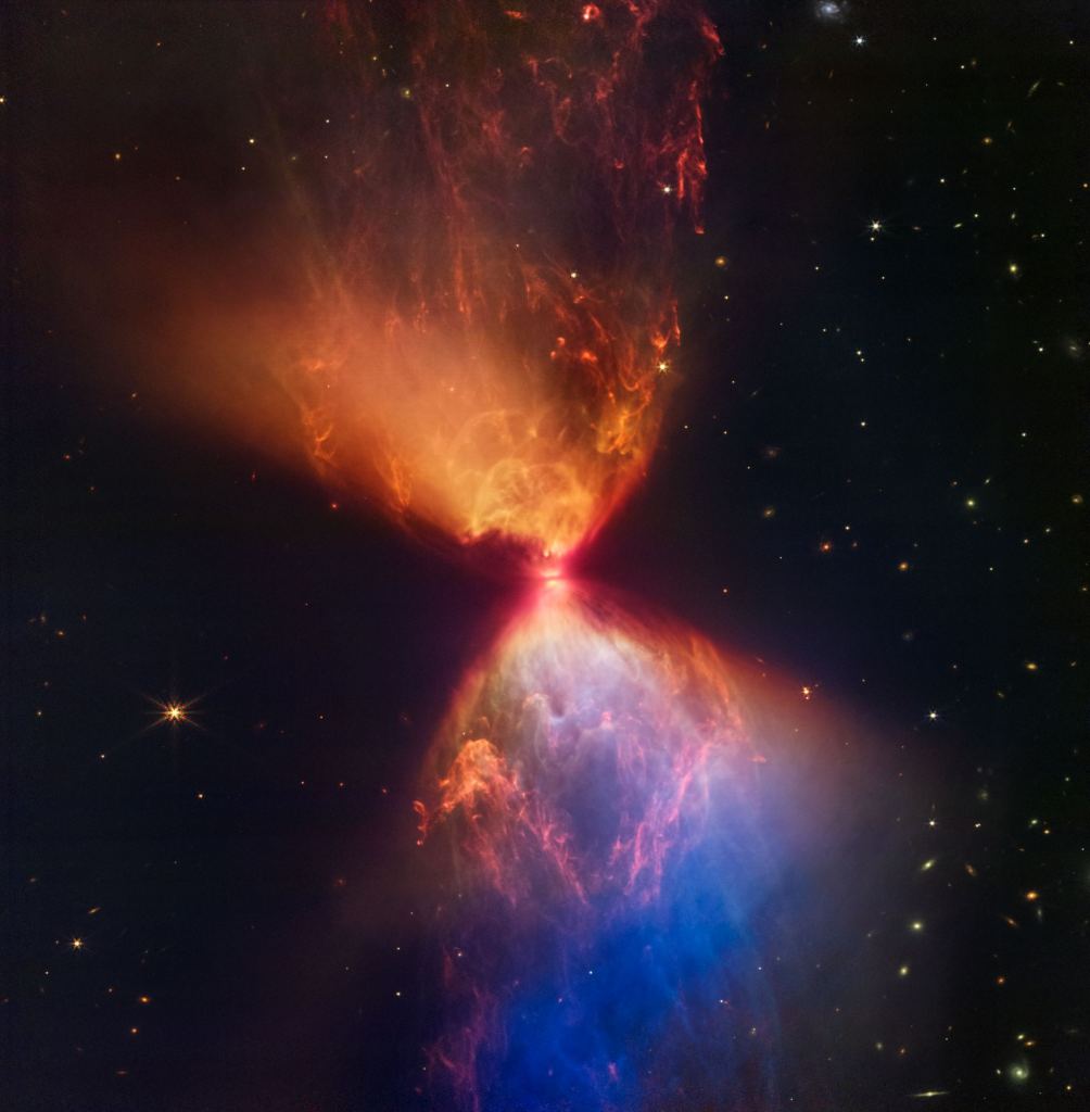The JWST captured this image of L1527 with its Near-Infrared Camera (NIRCam). The upper central region displays bubble-like shapes due to stellar "burps," or sporadic ejections. The different colours are from layers of dust. The more dust there is, the less blue light escapes. So, the orange/red regions are thicker dust than the blue regions. Image Credits: NASA, ESA, CSA, and STScI. Image processing: J. DePasquale, A. Pagan, and A. Koekemoer (STScI)