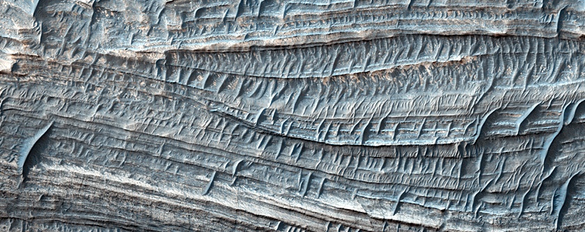 The walls of Valles Mariners are an ideal place to study Mars' layered geology, as shown in this HiRISE image of layered deposits. Scientists can learn about the planet's geological history without the need for excavation. Image Credit: NASA/JPL/UA/HiRISE