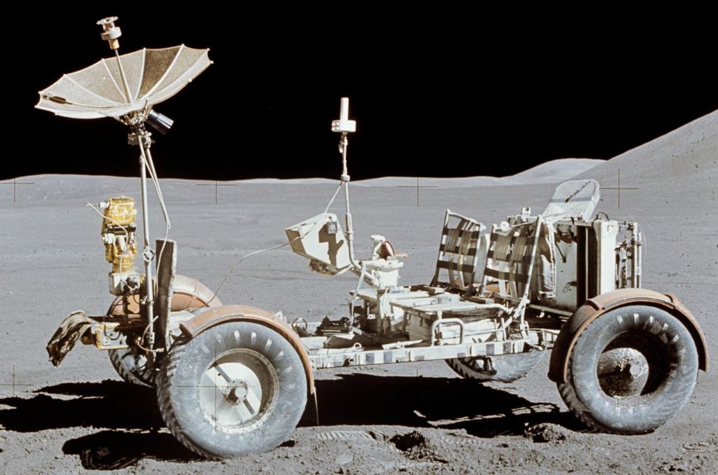 NASA used its 'Moon Buggy' or Lunar Roving Vehicle (LRV) on Apollo 15, 16, and 17 in 1971 and 1972. It could carry 440 kg, including two astronauts, and had a top speed of 18 km/h. Though it provided range and mobility, it never travelled further than walking distance from the landers in case of breakdown.  Image Credit: By NASA/Dave Scott; Public Domain, https://commons.wikimedia.org/w/index.php?curid=6057491