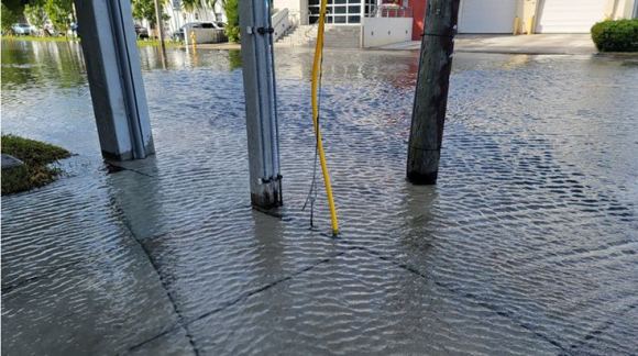 An example of sunny day king tide flooding submerging street infrastructure outside the City of Miami Fire Station 13. Sea level rise contributes to increased incidences of such flooding. Credit: Mike Sukop/NOAA. 